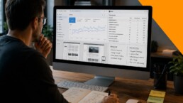 Ein Mann sitzt vor einem iMac und betrachtet Analysedaten zur Website-Optimierung